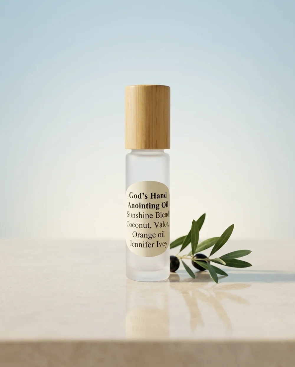 Sunshine Blend — 10ml frosted glass roller bottle with a bamboo cap, on a soft studio backdrop with an olive branch